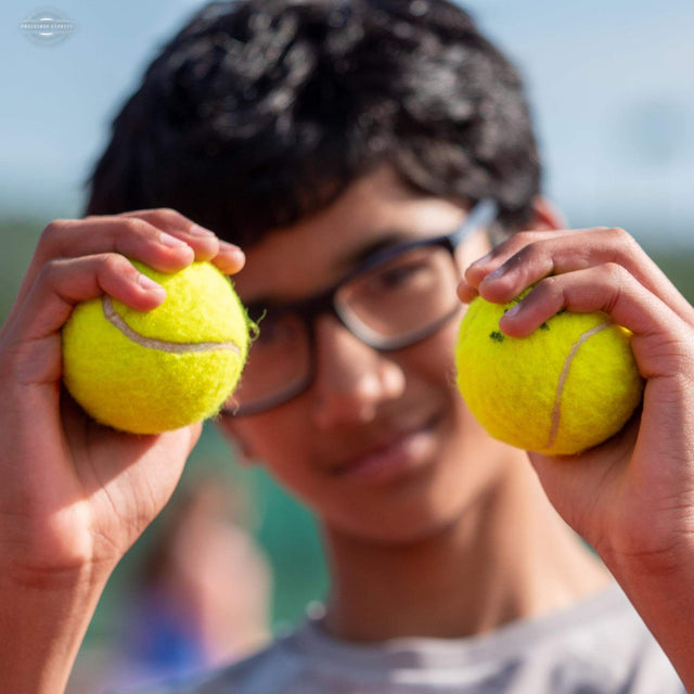 men showing tennis balls